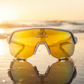 FortyFour Aura Sunglasses with gold mirror lens at sunset
