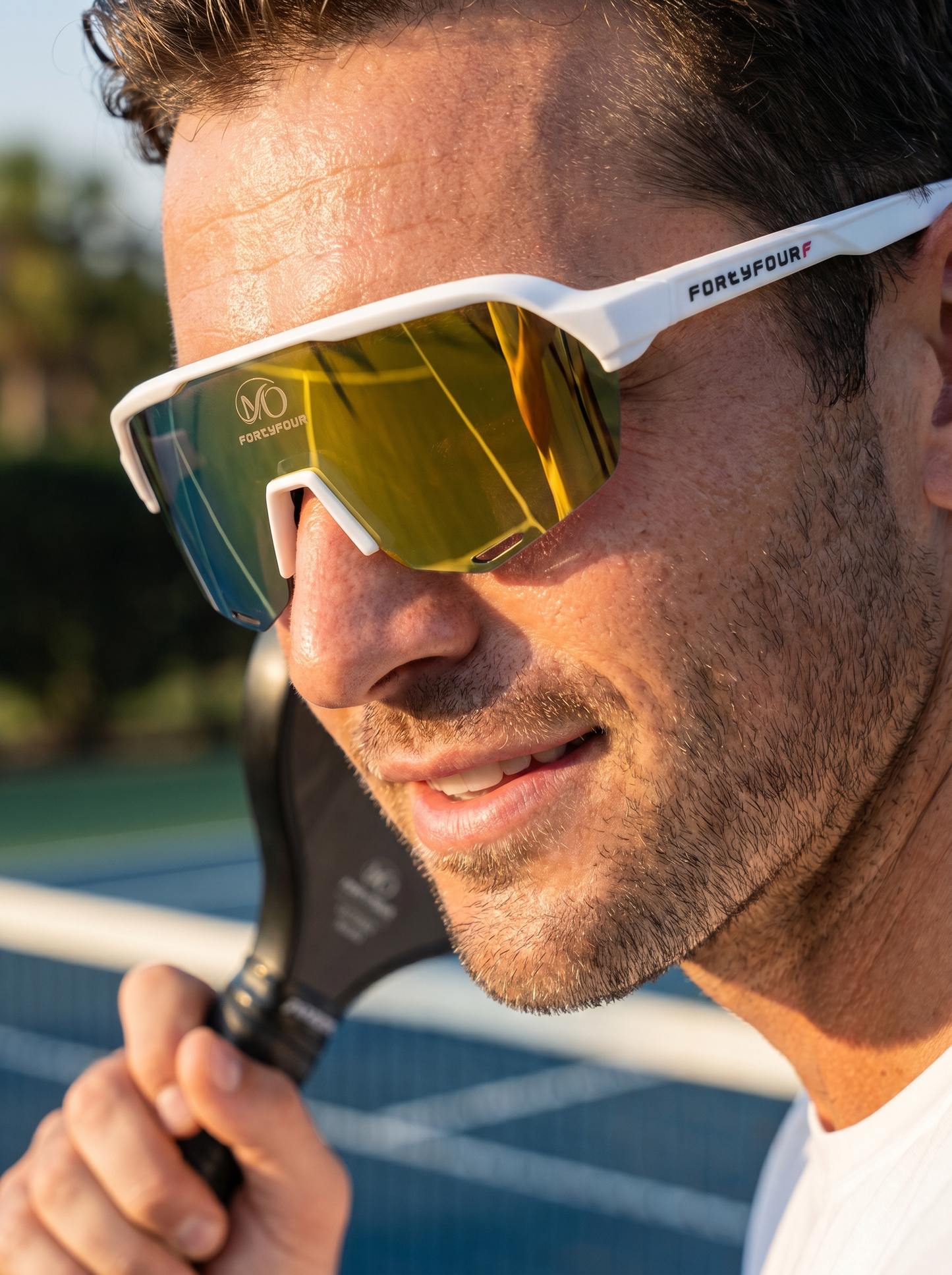 Male pickleball player wearing FortyFour Aura Sunglasses on the court
