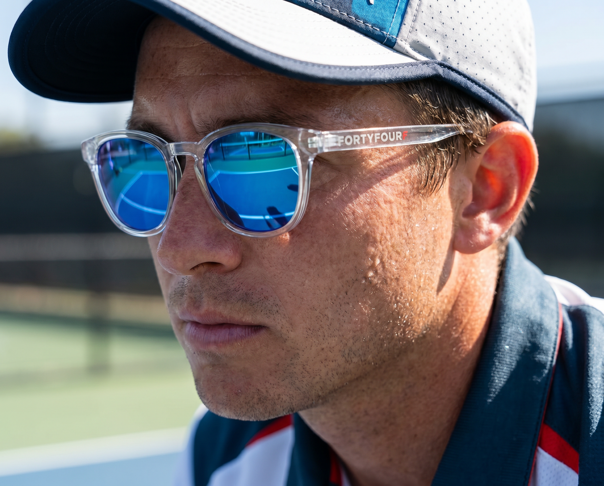 Male player wearing FortyFour Shades courtside