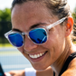 Player smiling courtside in FortyFour Shades with blue polarized lenses