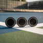 Anchor Cap weight coins standing on a pickleball court line