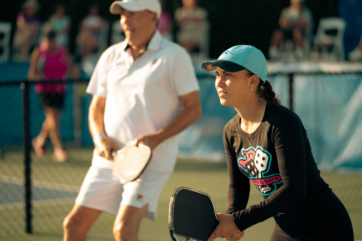 Fortyfour Sports team on a pickleball court in Fort Lauderdale inspecting professional carbon fiber paddles and padel equipment