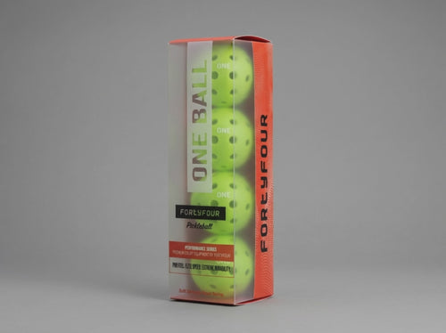 Fortyfour ONE Ball in play on outdoor hard court showing seamless construction and precision-drilled holes